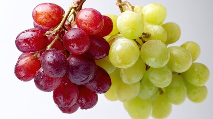Fresh grapes with contrast between red and green bunches on white background