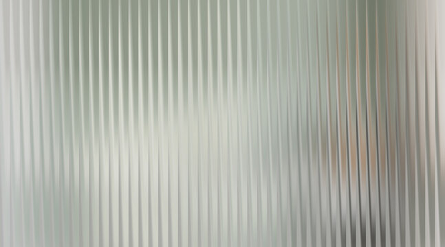 Frosted glass with vertical ribbed texture and blurred background