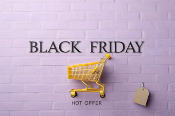 Modern Black Friday Discount Poster with Yellow Shopping Cart on Brick Wall Background
