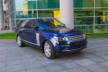 Luxury SUV near modern office building