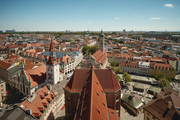 Aerial cityscape of Munich, Germany with historic architecture, red rooftops and churches. Beautiful view of old town and urban skyline.