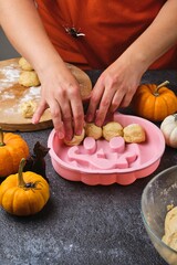 Step by step recipe for pumpkin bread shaped like a Halloween jack-o'-lantern on a dark concrete background. Halloween-themed baking. Holidays around the world.