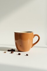 A terracotta coffee mug sits on a bright white surface, bathed in sunlight, with a scattering of roasted coffee beans nearby, creating a minimalist and calming scene.