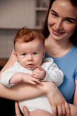 Joyful mother holding baby in cozy indoor setting, showcasing love and connection between parent and child, nurturing bond, family moments, parenting concept