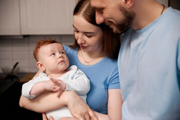 Loving family moment with parents and baby in cozy kitchen setting showcasing warmth, connection, and joy of parenthood, family bonding concept