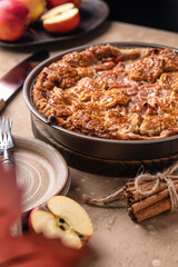 Homemade Apple Pie with fresh apples on brown background close up. Thanksgiving traditional dessert, autumn baking, recipe