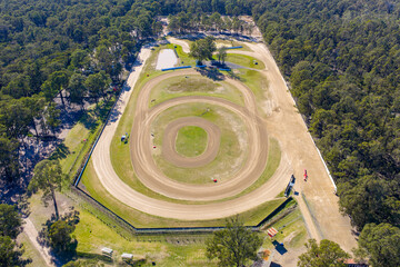 Drone aerial photograph of the Nepean Raceway speedway dirt track surrounded by trees and bushland in the greater Penrith region of NSW, Australia.