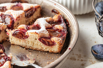 Homemade The New York Times plum cake. Sliced summer or autumn fruit pie in baking dish. Home cooking, recipe