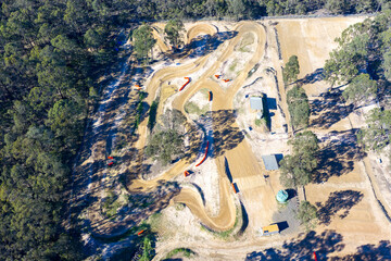 Drone aerial photograph of the Penrith Mini Bike Club speedway dirt track surrounded by trees and bushland in the greater Penrith region of NSW, Australia.