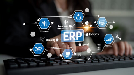 A focused business professional uses a keyboard to navigate a digital ERP interface, highlighting various system features essential for effective enterprise management. Tessel