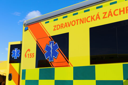 Ambulance emergency vehicle in the Czech Republic and Czechia. Text translated from Czech: Medical rescue. Detail of yellow car with bright reflective colors and symbol Rod of Asclepius.