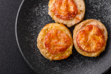 Round fish or chicken cutlets baked with tomato and cheese. Fish cutlets