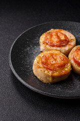 Round fish or chicken cutlets baked with tomato and cheese. Fish cutlets