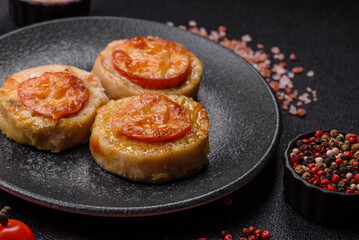 Round fish or chicken cutlets baked with tomato and cheese. Fish cutlets