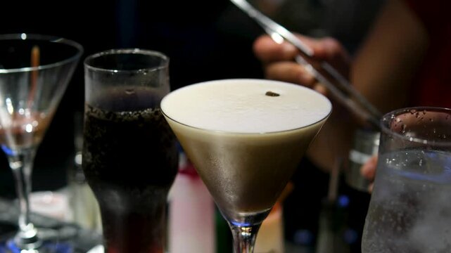 Bartender Puts Piece Of Fruit On Cocktail With Foam.