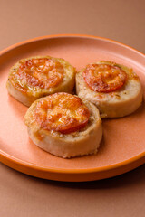 Round fish or chicken cutlets baked with tomato and cheese. Fish cutlets