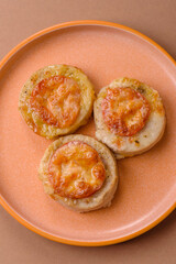 Round fish or chicken cutlets baked with tomato and cheese. Fish cutlets