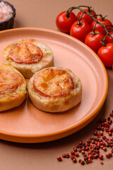 Round fish or chicken cutlets baked with tomato and cheese. Fish cutlets