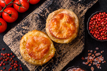 Round fish or chicken cutlets baked with tomato and cheese. Fish cutlets