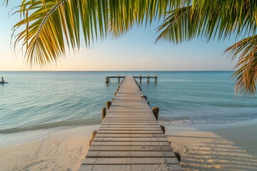Obraz premium Beautiful tropical shoreline with turquoise sea soft white sand and blue sky.