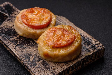 Round fish or chicken cutlets baked with tomato and cheese. Fish cutlets
