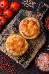 Round fish or chicken cutlets baked with tomato and cheese. Fish cutlets
