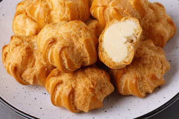 Cakes profiteroles arranged on a plate ready for enjoyment during a cozy afternoon