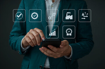 Business professional using smartphone with quality management icons overlay