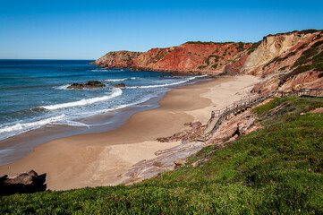 Praia do Amado, Algarve, Portugal.  The blue sky and calm water disguise the often wild and windswept Atlantic west coast of Portugal