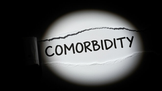 Comorbidity psychology. The word &ldquo;Comorbidity&rdquo; on torn white paper under spotlight. Concept of medical diagnosis, chronic diseases, and multiple health conditions in healthcare and research context.