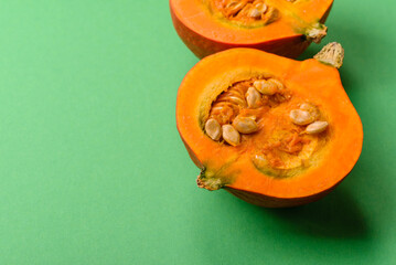 Half a raw pumpkin, a ripe orange colored butternut squash. Raw pumpkin