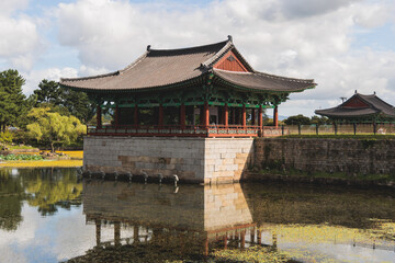Fototapeta premium Gyeongju, South Korea, view of Donggung Palace and Wolji Pond in a sunny day, North Gyeongsang Province, Gyeongju city, Silla dinasty traditional Korean hanok architecture, Yeongnam region
