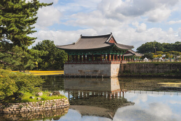 Fototapeta premium Gyeongju, South Korea, view of Donggung Palace and Wolji Pond in a sunny day, North Gyeongsang Province, Gyeongju city, Silla dinasty traditional Korean hanok architecture, Yeongnam region