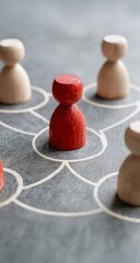 Isolated red pawn stands out among pale figures on network grid representing leadership and unique connection