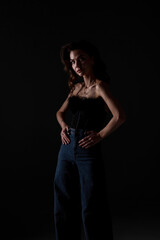Naklejka premium Model poses confidently in stylish outfit against dark background