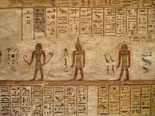 VALLEY OF THE KINGS, EGYPT : Interior of a tomb in the Valley of the Kings, featuring intricate wall paintings and hieroglyphs that tell stories of ancient Egyptian pharaohs.