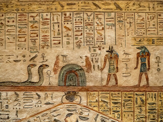 VALLEY OF THE KINGS, EGYPT : Interior of a tomb in the Valley of the Kings, featuring intricate wall paintings and hieroglyphs that tell stories of ancient Egyptian pharaohs.