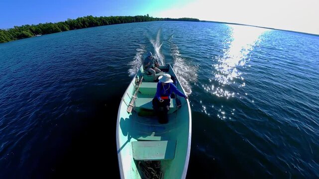 Fishermen on vacation, boating in lake Manitou, Manitoulin Island, Ontario, Canada. End of fishing game tournament. Water sport at fall. Power sport fishing and watersport.