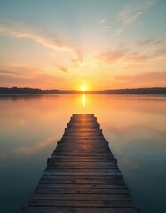 Fototapeta premium Wooden pier on calm lake water at golden sunset. Still reflections mirror orange sky and clouds. Peaceful nature scenery, perfect for relaxation and travel.