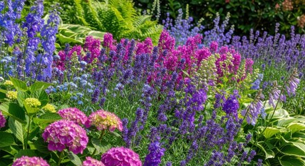 Colorful perennial flower bed with lavender and delphiniums in a summer garden.