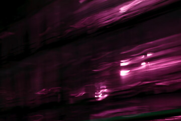 A futuristic motion blur background with vibrant pink and purple horizontal lines, creating a sense...