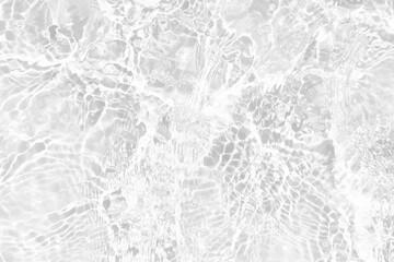 White water with ripples on the surface. Defocus blurred transparent white colored clear calm water surface texture with splashes and bubbles. Water waves with shining pattern texture background.