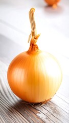 Single yellow onion on a light wood surface