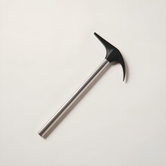 A close-up studio shot of a shiny, metallic ice axe resting on a plain, light-colored surface.