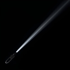 A flashlight emits a bright beam of light across a dark background, illuminating the space.
