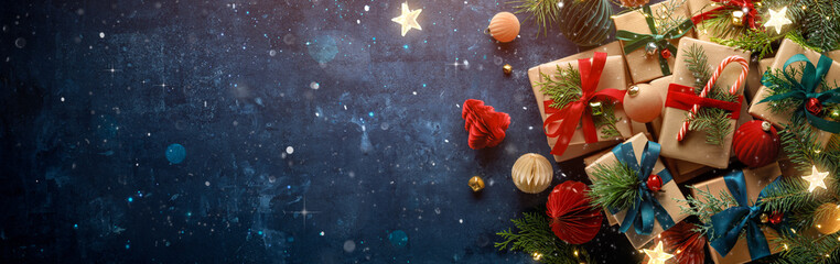 Dark blue Christmas background with gift boxes and fir branches.Merry Christmas.Happy new year banner