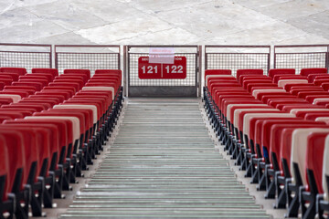 Red and white seating and staircase inside a giant stadium