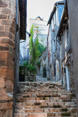 Old staircase in the town of Terrasson, forming a narrow alleyway lined with houses