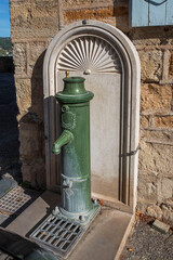 Antique manual water pump in the city