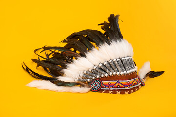 Traditional warbonnet (Native American chief headdress) on yellow background